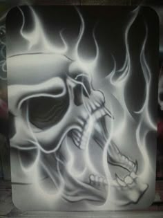 a painting of a skull with flames on it