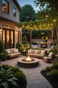 a fire pit surrounded by patio furniture and lights