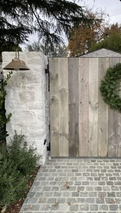 a wooden gate with a wreath on it