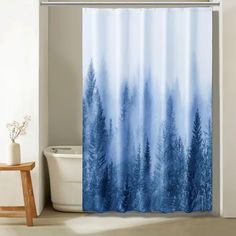 a shower curtain with blue trees on it