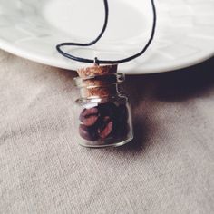 a glass jar filled with nuts sitting on top of a table next to a plate