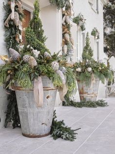 an instagram photo with christmas decorations and greenery on the side of a building