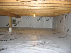 an unfinished room with white tarp covering the floor