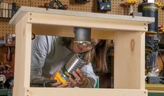 a woman is working on a project in a workshop