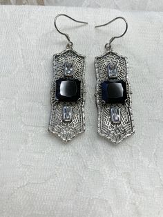 "Black Cubic Zirconia Earrings Square Peg Design#E63 Custom Made About 12 months ago I found a lovely Art Deco brooch and fell in love with the design. Fashioned in the design of the brooch, I now offer these lovely Antique reproduction earrings in sterling silver (matching pendant also available for sale in my store). The 3ct simulated black cubic zirconia gemstone is 10mm in L & W (3/8th\"). The 2 baguette CZ gems are 6mm x 3mm. The pendant is 1 3/4 inches long, it is just shy of 5/8th\" a Art Deco Silver Earrings With Cubic Zirconia, Black Filigree Earrings As Gift, Black Filigree Earrings For Gift, Elegant Black Filigree Earrings, Formal Black Filigree Earrings, Pierced Sterling Silver Jewelry For Evening, Nickel-free Black Earrings For Anniversary, Black Filigree Dangle Jewelry, Nickel Free Black Earrings For Anniversary