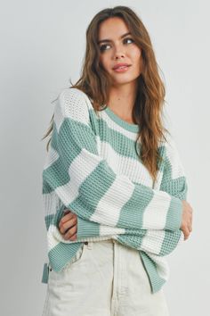 Stay stylish and cozy with our Striped Round Neck Long Sleeve Sweater. Crafted with comfort in mind, this sweater features a classic round neckline and long sleeves to keep you warm during chilly days. The charming striped pattern adds a touch of timeless flair to your wardrobe, making it a versatile piece for casual outings or relaxed days at home. Made from soft, high-quality fabric, this sweater offers both comfort and style, making it a must-have addition to your collection. Striped Long Sleeve Ribbed Sweater, Trendy Striped Sweater With Ribbed Cuffs, Striped Knit Long Sleeve Sweater, Striped Long Sleeve Knit Sweater, White Long Sleeve Sweater With Horizontal Stripes, Knit Crew Neck Sweater With Horizontal Stripes, Knit Sweater With Horizontal Stripes And Crew Neck, Trendy Horizontal Stripe Winter Sweater, Trendy Horizontal Stripe Sweater For Winter