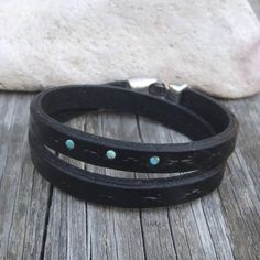 Made from top quality vegetable tanned leather.Hand painted and stamped leather wrap around bracelet. It is embellished with natural Tibetan Turquoise cabochons.Bangle is 1 cm wide and with zamak clasp closure.Please measure carefully your wrist and select the most preferable size!If you need a diferent size, please let me know after purchase in "note for seller".Please visit to my another shop:https://www.etsy.com/shop/JeansBelt?ref=hdr_shop_menu************************************************* Rustic Hand Tooled Adjustable Bracelets, Adjustable Hand Tooled Western Leather Bracelet, Turquoise Leather Concho Bracelets, Western Style Turquoise Leather Bracelets, Rustic Leather Concho Bracelets, Adjustable Turquoise Leather Bracelet In Rustic Style, Southwestern Hand Tooled Leather Bracelets, Adjustable Black Hand Tooled Bracelet, Adjustable Rustic Turquoise Leather Bracelet