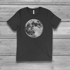 Women's graphic T-shirt with a Full Moon screen printed design. Unisex sizing with a super soft hand and comfortable fit.  See image chart for colors and size.  FIT NOTE & COLOR - See image size chartUnisex Fit: Runs large / Longer Length We suggest SIZING DOWN one from your normal women's size.Chest measurement shown on chart is actual garment size. PLUS SIZE for most 0X = L relaxed fit1X = XL relaxed fit2X = XXL relaxed fit-  Bella 3.8 oz  Super Soft hand / light weight -  Tri Blends:  50% Black Moon Print Graphic Tee, Black Graphic Tee With Moon Print, Black Top With Sublimation Print In Ring-spun Cotton, Unisex Crew Neck Shirt With Front Print, Black Cotton T-shirt With Moon Print, Cotton Crew Neck Top With Moon Print, Tri-blend Ring-spun Cotton Tops With Front Print, Casual Relaxed Fit T-shirt With Moon Print, Crew Neck Top With Front Print In Ring-spun Cotton