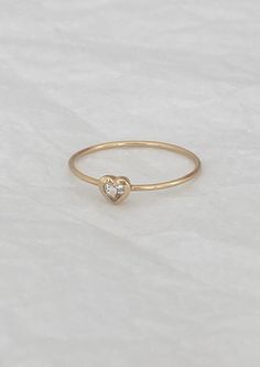 14k yellow gold sweetheart ring with 3mm heart-shaped white topaz and 0.9mm round band. Made here in New York from recycled materials. This product is handmade to order; please allow 2-3 weeks for shipping. For more information about this product or if you need it sooner, email us. Please refer to our ring size guide for assistance with sizing. Details here on how to care for this piece. Simple Stacking Rings, Solitaire Bands, Baby Heart, Ring Sale, Ring Size Guide, White Topaz, Stacking Rings, Black Diamond, 3 Weeks