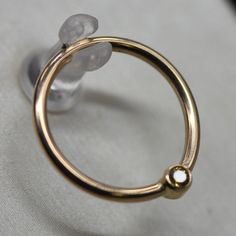 "16g 5/16 Solid 14k Gold (NOT plated or filled) With Real 2mm Yellow Sapphire THE PERFECT CLASSY EVERY DAY RING! The seam ring is designed to keep your jewelry from falling out and keep it snugly in place. These are perfect for nostril piercings, lobe piercings and smaller-gauge cartilage! To put them in, bend the ring sideways and simply bend it back into place. WHAT'S THE DIFFERENCE IN GOLD COLORS? The three different gold colors are the perfect array. The yellow gold is just the right hue, an 14k Gold Septum Ring For Anniversary, 14k Gold Round Septum Ring For Anniversary, Gold Septum Ring For Anniversary, Yellow Gold Nose Rings For Anniversary, Gold Hypoallergenic Nose Rings For Anniversary, Yellow Gold Round Nose Ring For Anniversary, Anniversary Yellow Gold Round Nose Rings, Anniversary Yellow Gold Nose Rings, Internally Threaded 14k Gold Nose Rings