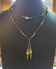 "Knotted Bead Wrap Wrap Necklace. Green, Brown, Tan, and White. Silk cord thread. Boho Style. May be wrapped in many ways. 41\" long." Neaded Necklace With Tassels On Lanyard Cord, Adjustable Green Beaded Lariat Necklace, Adjustable Green Bohemian Lariat Necklace, Adjustable Beaded Brown Lariat Necklace, Adjustable Wire Wrapped Beads For Jewelry Making, Adjustable Brown Beaded Lariat Necklace, Thread Necklace Diy, Knotted Necklace Diy, Silk Thread Necklace