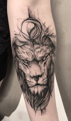 a black and white tattoo of a lion on the left arm with an arrow in its mouth