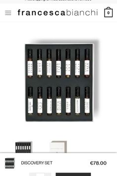 an assortment of different types of perfumes in a black box with white writing on it