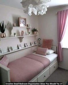 a bedroom with pink and white decor in the corner, including a twin size bed