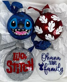 three christmas ornaments in a box with the words live stitch and obama jean's family painted on them