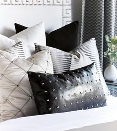 black and white pillows on a bed in a bedroom