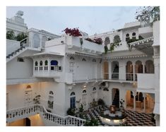 the inside of a white building with many balconies and balconyes on each floor