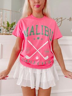 The Sassy Shortcake Malibu Golf Club Tee is a hot pink preppy graphic tee. She features twin golf clubs in white and the text "Malibu Golf Club" in green. Classic fit + unisex sizing. She is paired here with our white pinkalicious skirt. Fits true to size. Model is wearing a size small. Hot Pink Preppy, Sassy Shortcake, Mental Health T Shirts, Preppy Shorts, Fancy Fits, Pink Preppy, Just My Size, Rainbow Shirt, Cute Fits