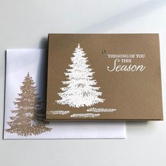 a card with a christmas tree on it and the words, thinking of you this season