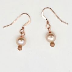 Creamy Satiny White Freshwater Pearls 14k Rose Gold Filled Earrings! This is for one pair of beautiful satiny Freshwater pearl EARRINGS. These enchanting & captivating earrings will compliment any skin tone. The pearls are a beautiful creamy white accented with beautiful Rose Gold!! NOTE: Images do not reflect number and size. Please see detail and table for information. Quantity: 1 pair of earrings Material Type: Fresh Water Pearls, 14k Rose Gold Filled Earrings Size: 6mm (Pearls) Length: 1 Dainty Rose Gold Round Pearl Earrings, Dainty Rose Gold Pearl Earrings, Delicate Hypoallergenic Rose Gold Pearl Earrings, Adjustable Rose Gold Pearl Drop Jewelry, Minimalist Hypoallergenic Rose Gold Pearl Earrings, Hypoallergenic Rose Gold Pearl Earrings, Hypoallergenic Minimalist Rose Gold Pearl Earrings, Rose Gold Pearl Earrings With Ear Wire For Anniversary, Hypoallergenic Rose Gold Round Pearl Earrings