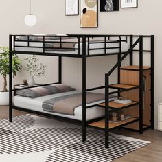 a black bunk bed with stairs in the middle and pictures on the wall above it