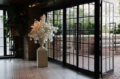 Ceremony-space-with-glass-doors-and-white-florals-at-NYC-wedding-at-the-Bowery-Hotel Wedding New York, Kleinfeld Bridal, Luxurious Wedding, Personal Celebration, Green Backdrops, Epic Photos