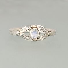 Rainbow Moonstone Ring with Leaves in Sterling Silver Nature-inspired Moonstone Ring, Nature-inspired Round Moonstone Ring In Sterling Silver, Nature-inspired Sterling Silver Moonstone Promise Ring, Ethereal Sterling Silver Moonstone Promise Ring, Handmade Nature-inspired Moonstone Ring For Anniversary, Nature-inspired Handmade Moonstone Ring For Anniversary, Nature-inspired Moonstone Wedding Ring, Handmade Delicate Moonstone Promise Ring, Unique Moonstone Promise Ring As Birthstone