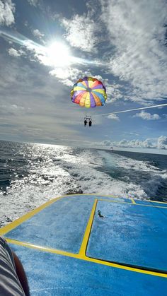 a person is parasailing over the ocean on a sunny day with blue skies and white clouds