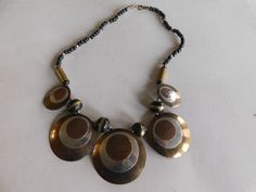 "Multicolor Brass Black Silver Boho Statement Bib Necklace Good condition with minimal wear, does require polishing 24\" long and bib measures 8 3/4\" wide by 2 1/4\" (circle size) We appreciate you taking the time to stop by our store. If we can be of any assistance, please let us know. For more beautiful vintage jewelry and other items, click here: http://www.etsy.com/shop/meetingofthefinds. For US customers: If you would like this item insured, please convo me before purchase and I will add t Handmade Circular Black Necklaces, Handmade Circular Black Necklace, Handmade Black Circle Necklaces, Handmade Black Circle Necklace, Black Metal Circle Necklaces, Black Circular Metal Necklace, Black Circle Metal Necklaces, Black Metal Circular Necklace, Black Metal Circle Necklace