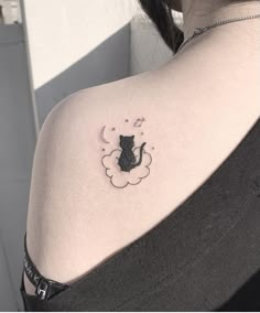 a woman with a cat tattoo on her shoulder