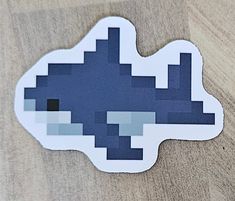 2.5" gloss sticker, shark blåhaj pixel art Small Shark Perler Beads, Sea Creature Pixel Art, Therian Pixel Art, Hamahelmet Ideas, Pixel Art 32x32 Easy, Shark Perler Bead Pattern, Winnie The Pooh Pixel Art, Bug Pixel Art, Jellyfish Pixel Art