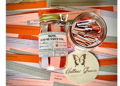 a jar filled with lots of pink and orange crayons next to a label