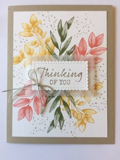 a card with some flowers on it and the words thinking of you written in white