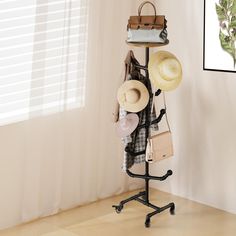 a hat rack with hats and purses on it in front of a white wall