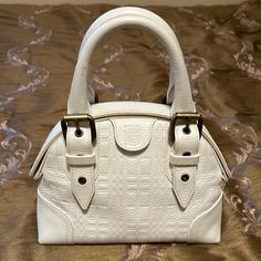 This Gorgeous Burberry Bag Is In Excellent Condition With Minimal Wear. Leather Is An Off White And Is Clean With Only Faint Tiny Spots That Are Not Readily Visible. Interior Is Clean And Has Zippered Pocket. Bag Has “Hinge” Opening With Magnetic Closure. 9.5” X 7” X 4” White Pebbles, Burberry Bag, Pebbled Leather, Zipper Pocket, Burberry, Zipper, Bag Lady, Handbags, Leather