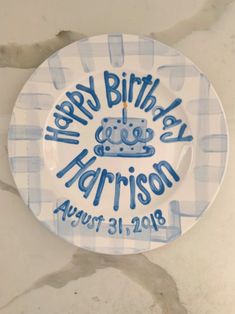 a blue and white plate with the words happy birthday harrison on it