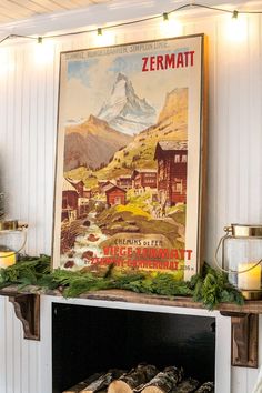 an old poster hangs on the wall above a fireplace with logs in front of it