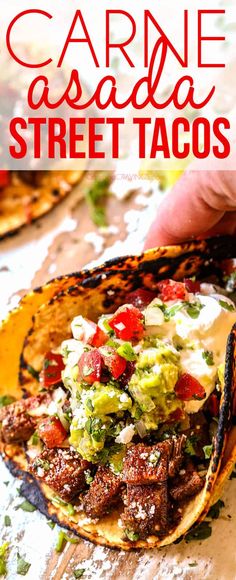 a hand holding a tortilla filled with meat and guacamole on top