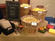 several buckets filled with popcorn sitting on top of a table