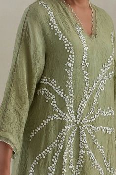 Green kaftan hand embroidered with flower motif, asymmetric hem and sheer scalloped border detailing on neck and cuffs. Paired with a flared pant with sheer border on hem and contrasting line on sides. - Aza Fashions Spring V-neck Kaftan With Chikankari Embroidery, Elegant Spring Tunic With Embroidered Neckline, Spring Embellished Kaftan, Spring Embellished Tunic, Summer V-neck Tunic With Chikankari Embroidery, Spring Embellished Tunic Kaftan, Elegant Kaftan With Chikankari Embroidery And V-neck, Elegant V-neck Kaftan With Chikankari Embroidery, V-neck Tunic With Chikankari Embroidery For Spring