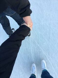 two people standing next to each other on an ice rink