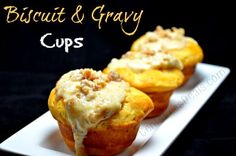 two muffins on a white plate with the words biscuit and gravy cups