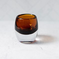 a brown and white glass sitting on top of a table