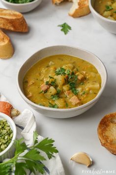 bowls of soup and bread on a table