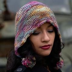 a woman wearing a multicolored knitted hat