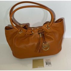 Michael Kors East West Leather Ring Tote Tangerine Orange Color Handbag Is Medium In Size And Brand New With Tags. Soft Luxurious Leather Bag W/ Leather Tassel, Mk Logo Charm, Top Magnetic Closure, Cinched Top With Grommet Detail, Logo Print Lining, Interior Zip Pocket, Cell Phone Pocket, Extra Pockets. The Measurements Are 13"W X 10"H X 8"D With An 8" Drop. The Msrp Is $348.00 Brand New With Tags Fast Shipping! Great Valentines Day Gift! Fast Shipping! Orange Leather Shoulder Bag With Gold-tone Hardware, Orange Leather Bags With Branded Hardware, Orange Shoulder Bag With Gold-tone Hardware For Shopping, Luxury Orange Soft Leather Bags, Michael Kors Cognac Shoulder Bag For Shopping, Orange Shoulder Bag With Dust Bag Included, Elegant Orange Bags With Gold-tone Hardware, Elegant Orange Shoulder Bag With Leather Handles, Elegant Orange Leather Shoulder Bag