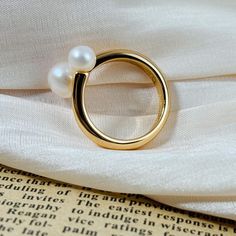 🌻This minimalist ring combines natural pearls with gold-plated silver, enhanced by a unique design. 🥰This piece is meticulously crafted from S925 sterling silver and pearl (total 4.0g) and finished with a luxurious coating of genuine 18k gold plating. 🥰This ring is adjustable to fit your desired size. 🥰We will send it in a beautiful jewelry box and package it carefully. We offer boxes in blue, green, white, and black. Please leave a message specifying your preferred color 🥰Please leave a me Everyday Gold Pearl Open Ring, Gold Everyday Pearl Ring With Pearl Drop, Everyday Gold Pearl Ring With Pearl Drop, Everyday Gold Pearl Drop Ring, Everyday Gold Ring With Pearl Charm, Everyday Yellow Gold Pearl Open Ring, Modern Gold Pearl Ring For Everyday, Modern Everyday Gold Pearl Ring, Everyday Gold Pearl Ring