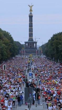 a large group of people running down a street