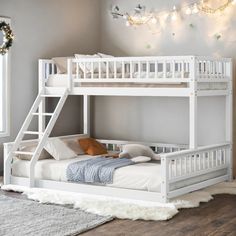 a white bunk bed sitting on top of a wooden floor