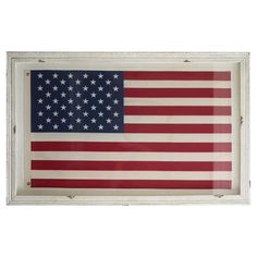 an american flag hanging in a white frame